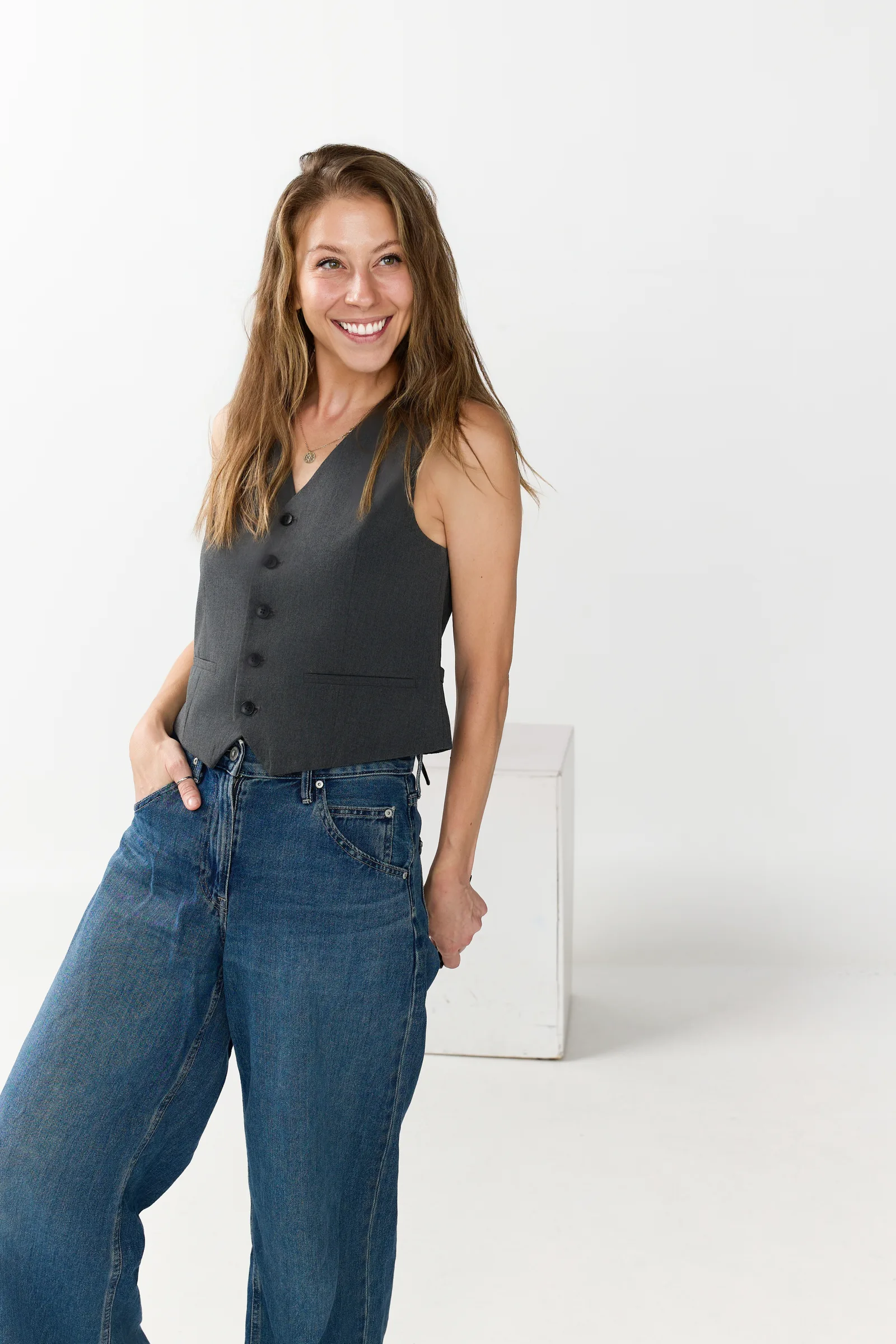 Jenna Stein wearing a charcoal vest and wide-leg denim